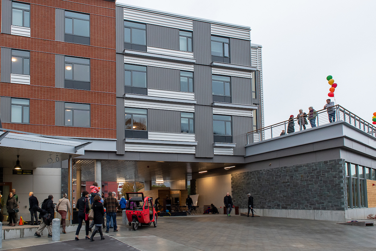 Image of folks walking around Taylor Street Apartments in Montpelier, Vermont